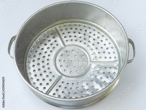 High angle view of old round silver aluminum steamer. It is commonly used in Taiwanese villages for steaming food. Retro style. Kitchenware concept.