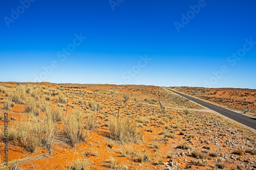 Photography Red sand dunes and road in Kalahari