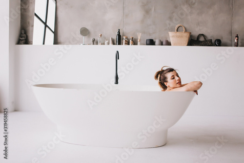 Beautiful woman relaxing in the bathtube. photo