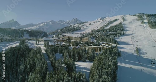 Drone shot of Courchevel, France, plenty of snow. View on the village and resort. nice forest  photo