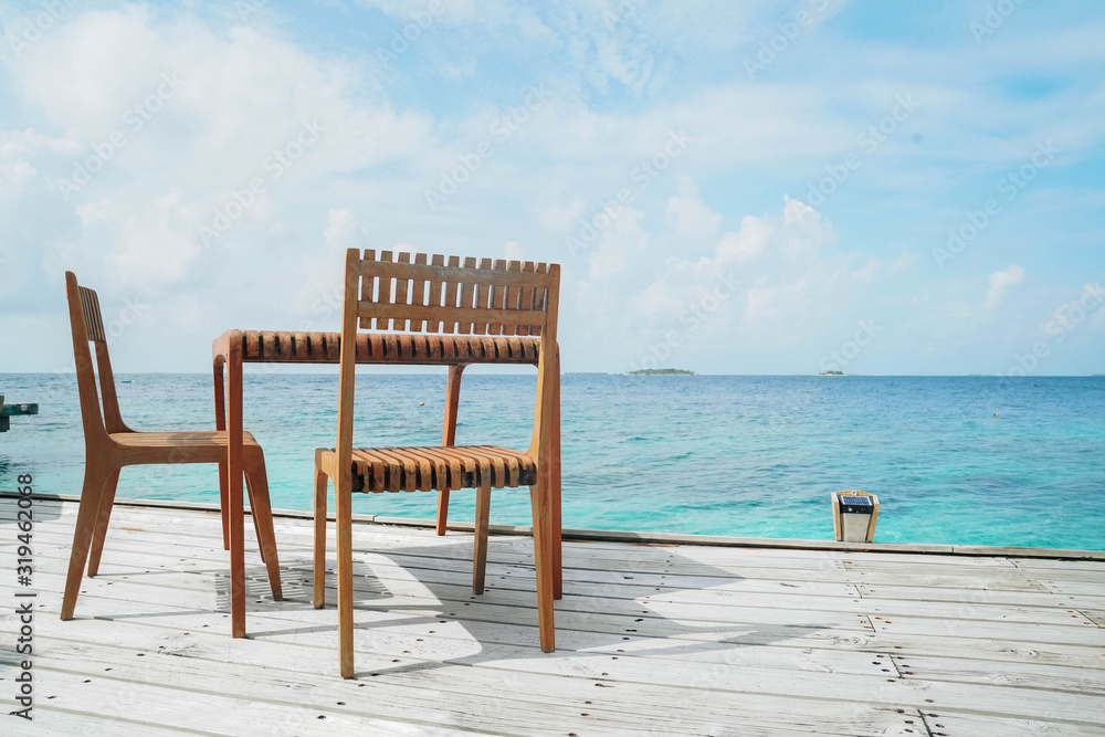 Outdoor terrace with Empty  wooden table and chair with Sea view of Indain ocean, Maldives background