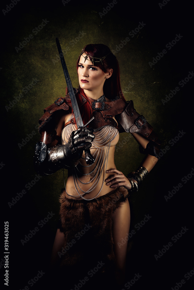 Portrait of a sexy warrior with a sword on her shoulder Portrait of a sexy warrior with a sword on her shoulder