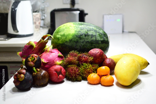 Assortment of exotic fruits on a white kitchen table