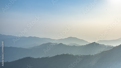 Green mountains in the fog. Seamless background. 