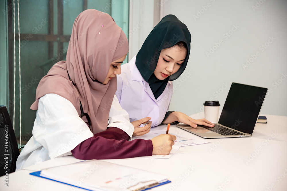 Asian muslim doctor work ,meeting hospitle.consult together.