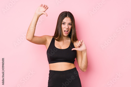 Young fitness caucasian woman isolated showing thumb down and expressing dislike. © Asier
