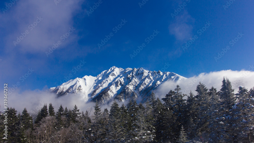 Japan Aleps mountains in winter cover with snow and blue sky during travel in Shinhotaka ropeway, Japan