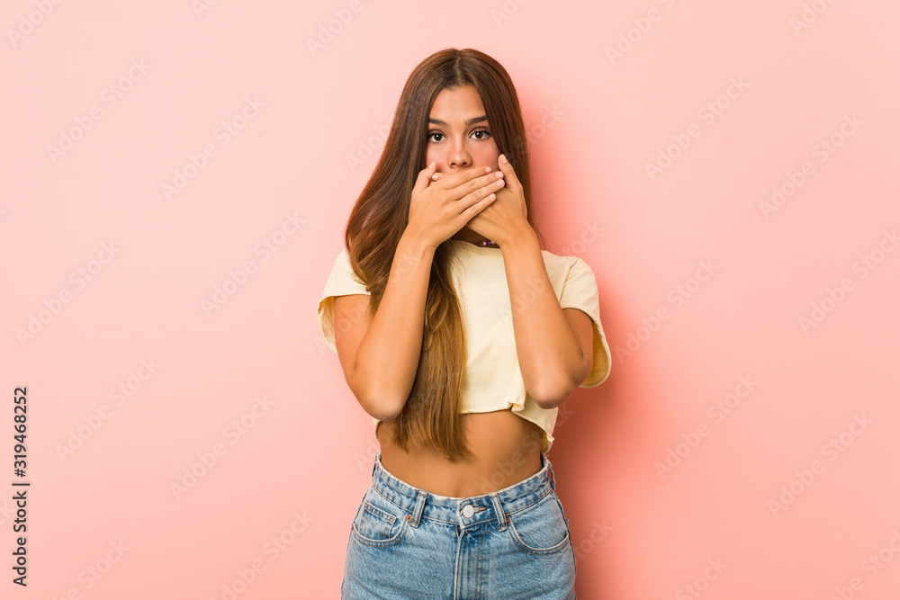 Young slim woman shocked covering mouth with hands. Young slim woman shocked covering mouth with hands.