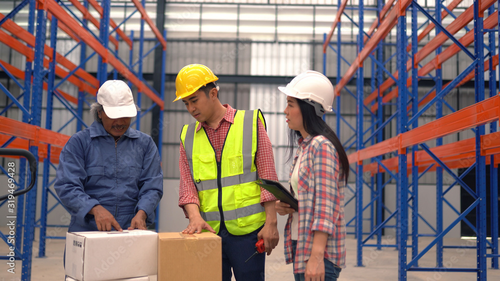 warehouse workers checking the shipment while working warehouse workers checking the shipment while working