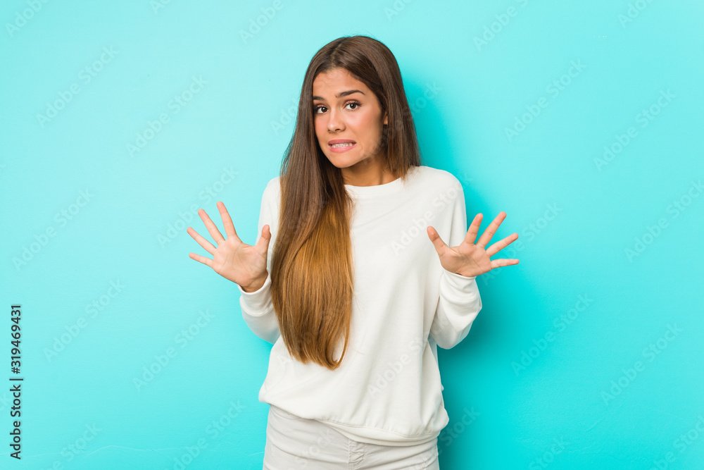 Young slim woman rejecting someone showing a gesture of disgust. Young slim woman rejecting someone showing a gesture of disgust.