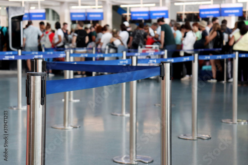 Queue of people in the airport building, selective focus. Passengers during registration to board the plane