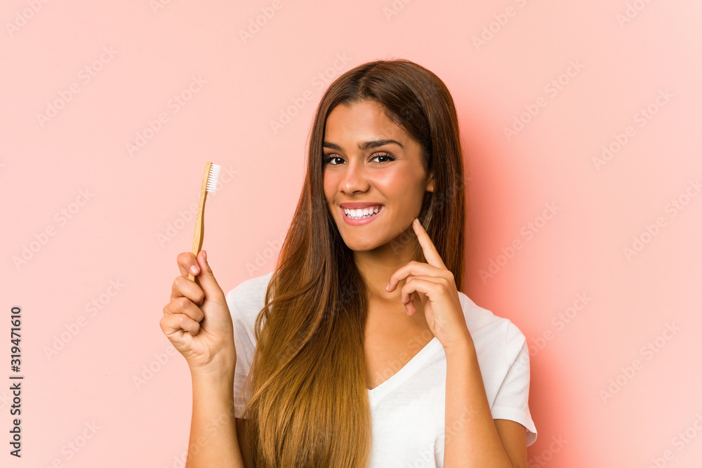 Young caucasian woman cleaning his teeth with a toothbrush isolated Young caucasian woman cleaning his teeth with a toothbrush isolated