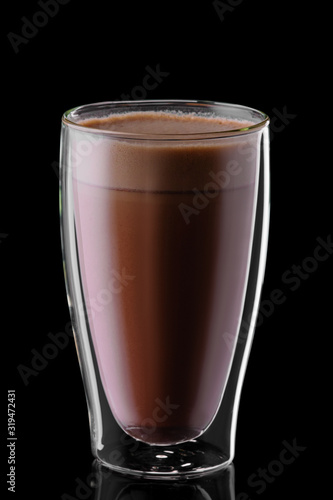 Double wall glass of hot chocolate isolated on black