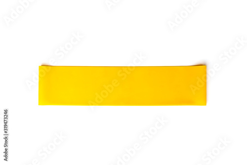 Yellow fitness elastic band for sport isolated on white background.