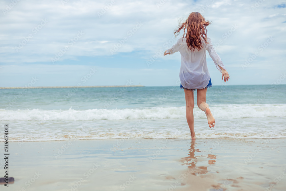 Young woman running playful on tropical beach in freedom. Young woman running playful on tropical beach in freedom.