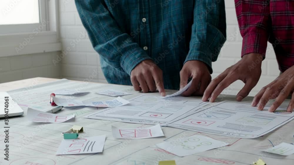 Web designer working laptop responsive design. Creative UI Ux designer teamwork meeting planning designing wireframe layout application development for smartphone screen mobile phone technology Web designer working laptop responsive design. Creative UI Ux designer teamwork meeting planning designing wireframe layout application development for smartphone screen mobile phone technology