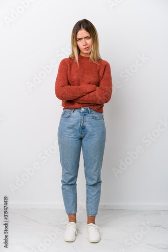 Quadro su tela Full body young caucasian woman frowning face in displeasure, keeps arms folded