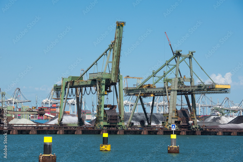 Netherlands, Rotterdam - July 30, 2019; Coal terminal wih big industrial cranes for handling coal transportation on the Maasvlakte in the port of Rotterdam