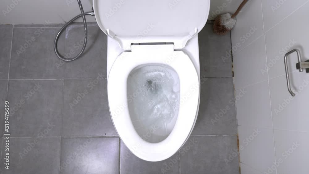 Vidéo Stock top view of Toilet Flushed. a water flushing down into the