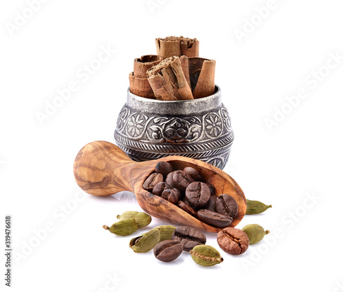 Coffee beans with cardamom and cinnamon isolated on white background. Coffee beans with spice. photo