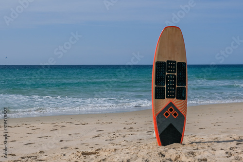 Surfboard standing in the sand on the beach