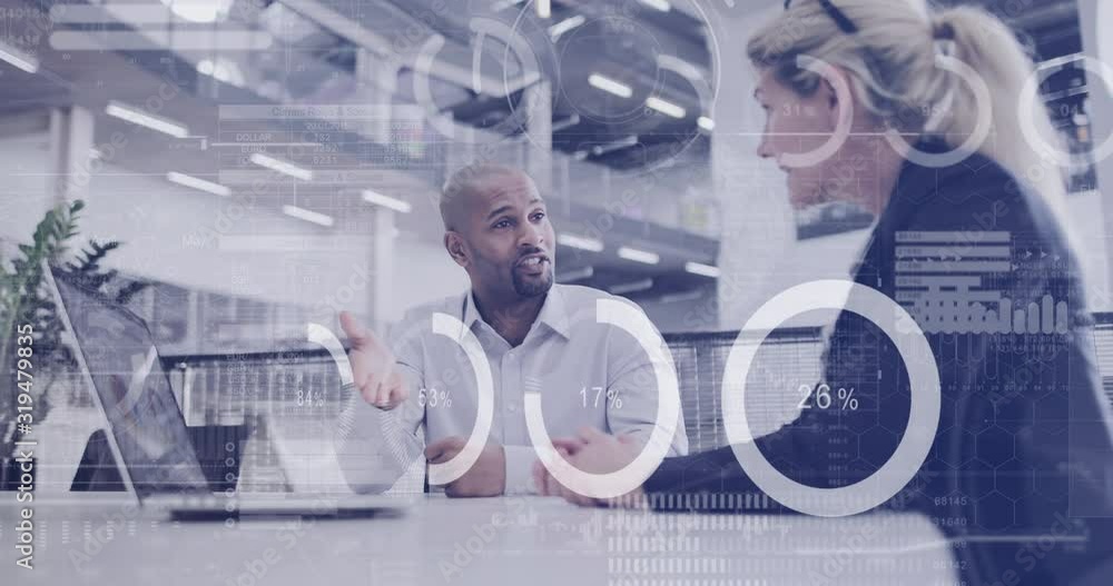 Digital composite of diverse business people in a meeting in office using digital tablet with graphics moving over the screen