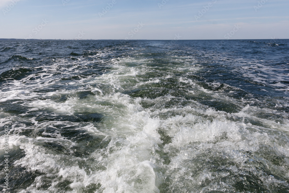 Water trail foaming behind a ferry boat in Baltic Sea Water trail foaming behind a ferry boat in Baltic Sea