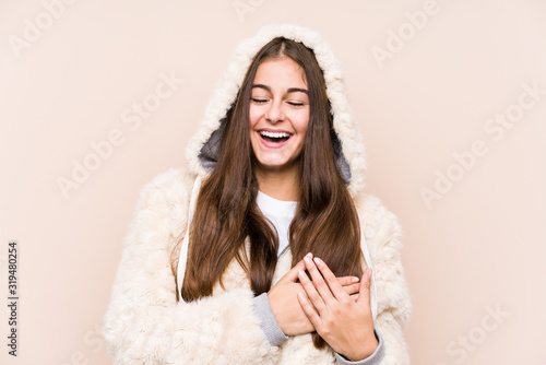 Young caucasian woman posing isolated laughing keeping hands on heart, concept of happiness.