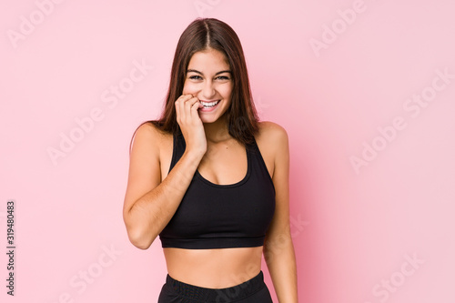 Young caucasian fitness woman doing sport isolated biting fingernails  nervous and very anxious.