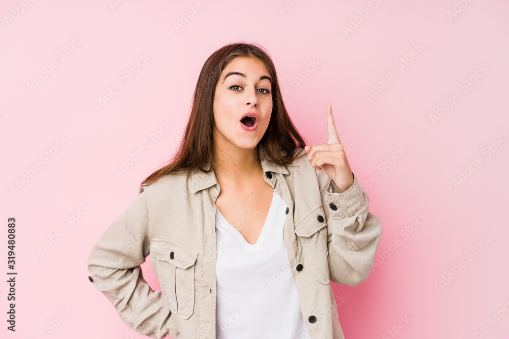 Young caucasian woman posing in a pink background having an idea, inspiration concept. Young caucasian woman posing in a pink background having an idea, inspiration concept.