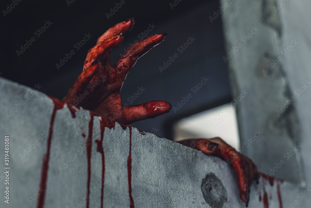 Naklejka horror scence of woman with scary hand at abandoned house. hand through the hole wall. Halloween concept