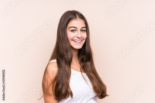 Young cute caucasian woman against a beige background