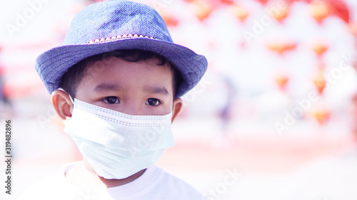 Pm2.5 and Coronavirus Air pollution concept. Little Asian or Chinese boy wearing mask for protect pm2.5 bad air. Wuhan coronavirus and epidemic virus from china.                                 