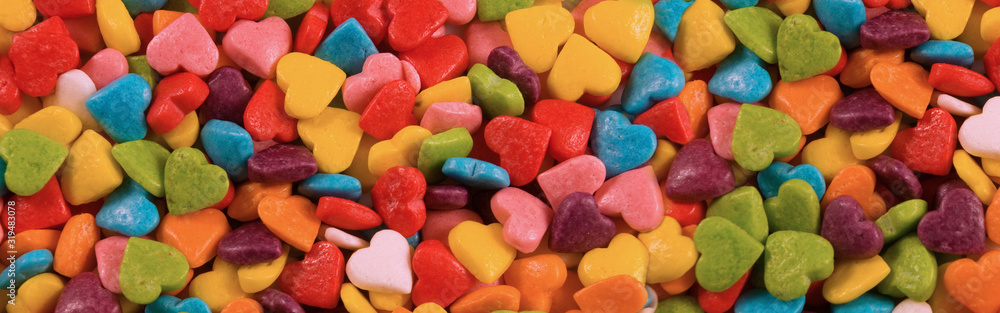 small multi-colored sweets scattered on the surface, shown close-up small multi-colored sweets scattered on the surface, shown close-up
