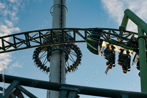 People screaming and holding up hands during roller coaster ride Helix at Liseberg amusement park Gothenburg Sweden - People having fun at their leisure. photo