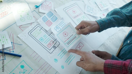 Web designer working laptop responsive design. Creative UI Ux designer teamwork meeting planning designing wireframe layout application development for smartphone screen mobile phone technology