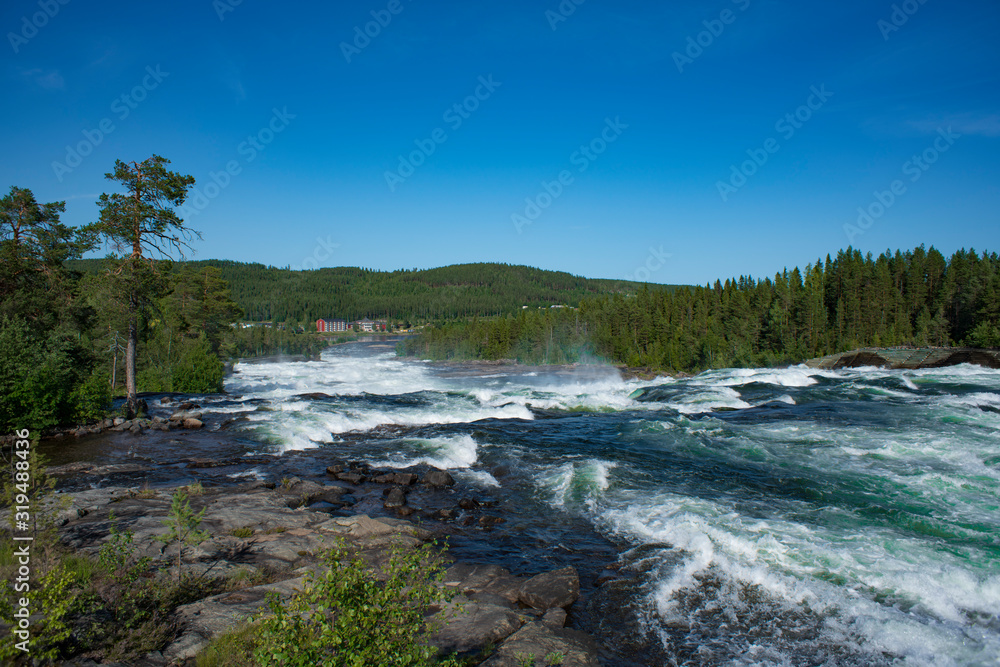 Storforsen river Sweden. Nature reserve on sunny summer day in Swedish lapland with Big river, rapids and waterfall. Storforsen river Sweden. Nature reserve on sunny summer day in Swedish lapland with Big river, rapids and waterfall.