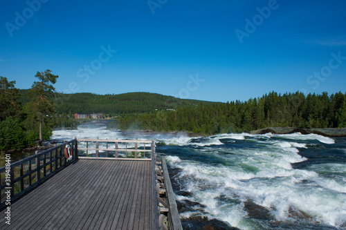 Storforsen river Sweden. Nature reserve on sunny summer day in Swedish lapland with Big river, rapids and waterfall. © Sebastian