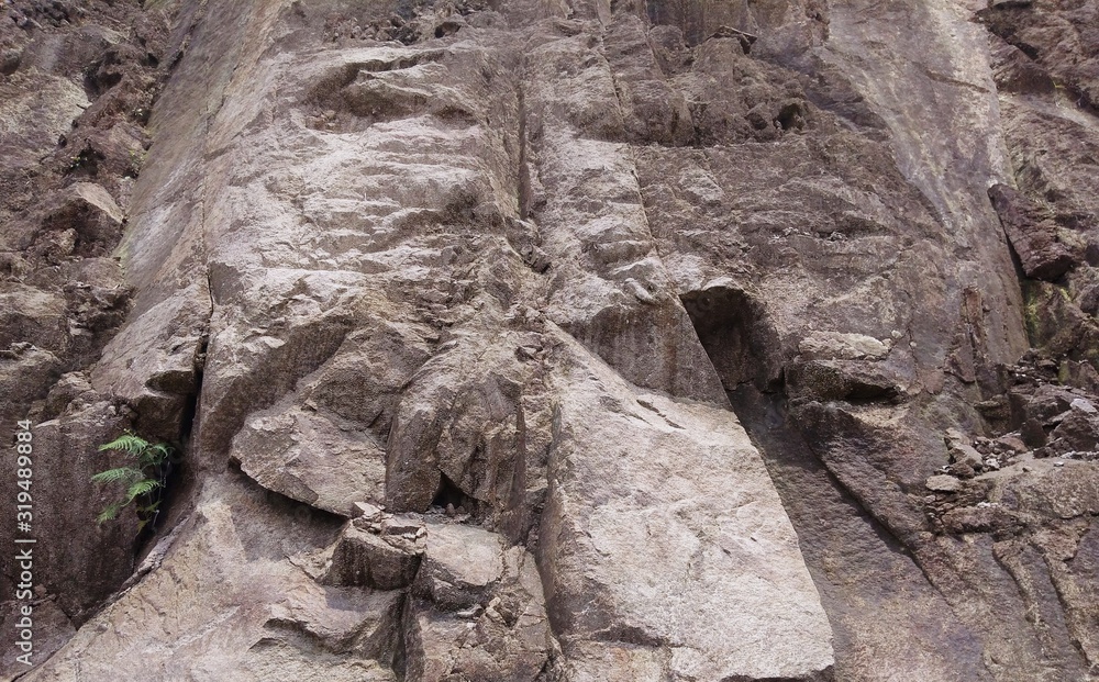 Obraz premium fractured granitic rocks outcrop near the road