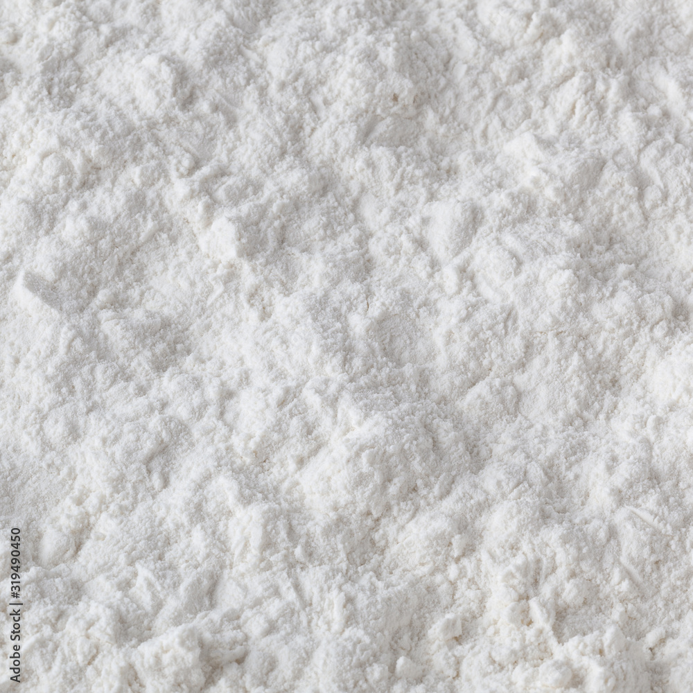 Uncooked white wheat flour background Uncooked white wheat flour background