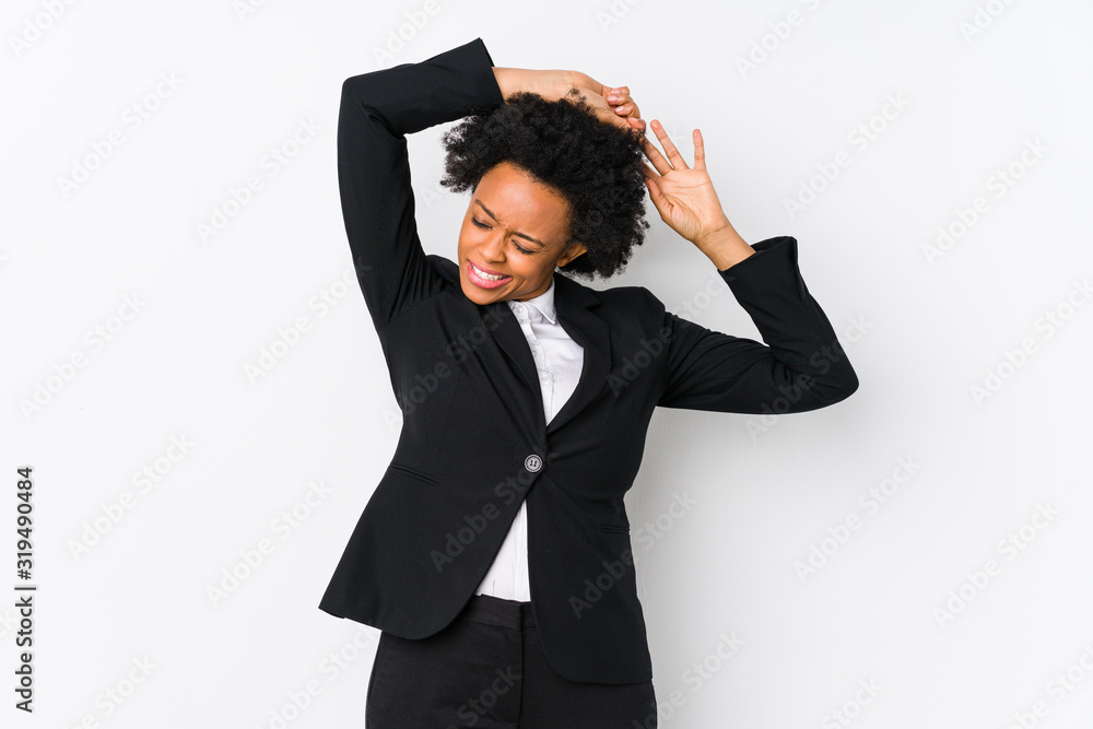 Middle aged african american business woman against a white background isolated stretching arms, relaxed position. Middle aged african american business woman against a white background isolated stretching arms, relaxed position.