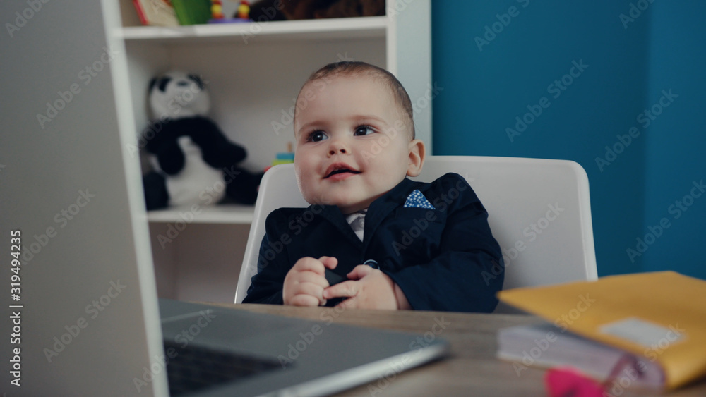 Close up view of extremely cute baby boss sitting in the office and smiling. Happy childhood, little cuteness, proud parents. Child’s portrait. Joke concept, positive emotions, feeling good Close up view of extremely cute baby boss sitting in the office and smiling. Happy childhood, little cuteness, proud parents. Child’s portrait. Joke concept, positive emotions, feeling good