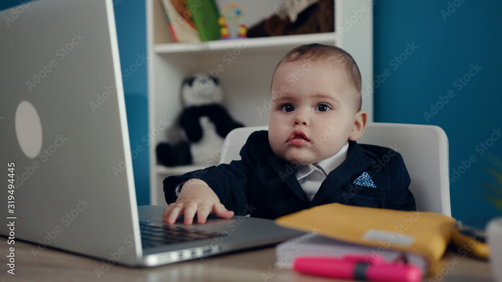 Extremely cute little toddler boy in business suit sitting in the office and working hard, actively tapping laptop’s touchpad. Cuteness, happiness, childhood. Prank, joke concept. Child’s portrait. Extremely cute little toddler boy in business suit sitting in the office and working hard, actively tapping laptop’s touchpad. Cuteness, happiness, childhood. Prank, joke concept. Child’s portrait.