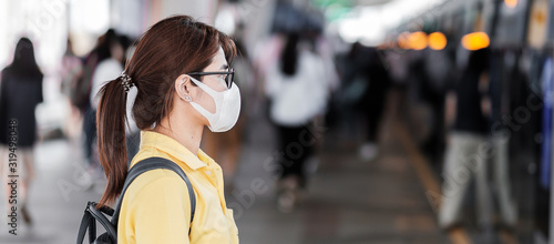young Asian woman wearing protection mask against Novel coronavirus (2019-nCoV) or Wuhan coronavirus at public train station,is a contagious virus that causes respiratory infection.Healthcare concept photo