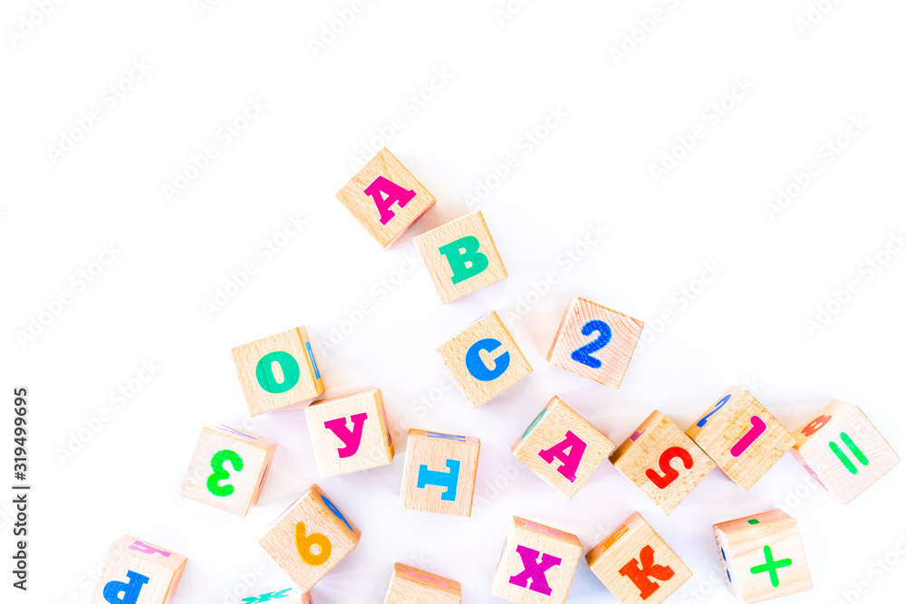 Kids toys wooden cubs with letters and numbers on white background. Developing wooden blocks. Natural, eco-friendly toys for children. Top view. Flat lay. Copy space. Kids toys wooden cubs with letters and numbers on white background. Developing wooden blocks. Natural, eco-friendly toys for children. Top view. Flat lay. Copy space.