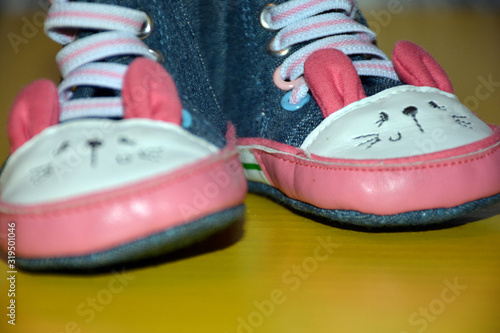 Blue kids shoes with pink soles and pink and white laces. Stylish baby. Fashion footwear. Children's sports shoes. Fashion