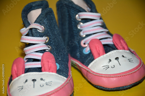 Blue kids shoes with pink soles and pink and white laces. Stylish baby. Fashion footwear. Children's sports shoes. Fashion
