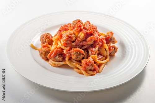 Plate of spaghetti with tomato and meatballs