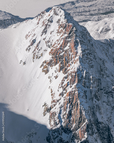 Aerial view of white Moutain with red rockface