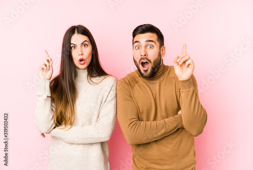 Young caucasian couple isolated having some great idea, concept of creativity.